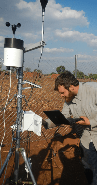 Image of Dr. Peter setting up a weather station in central Malawi.